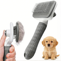 Self-cleaning dog deshedding brush with hand pressing button to release a clump of loose undercoat fur