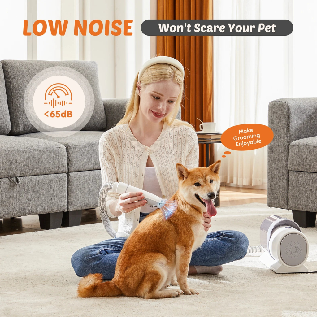 Pet grooming vacuum with clippers running under 65 dB low noise while a woman grooms a relaxed Shiba Inu on a living room rug