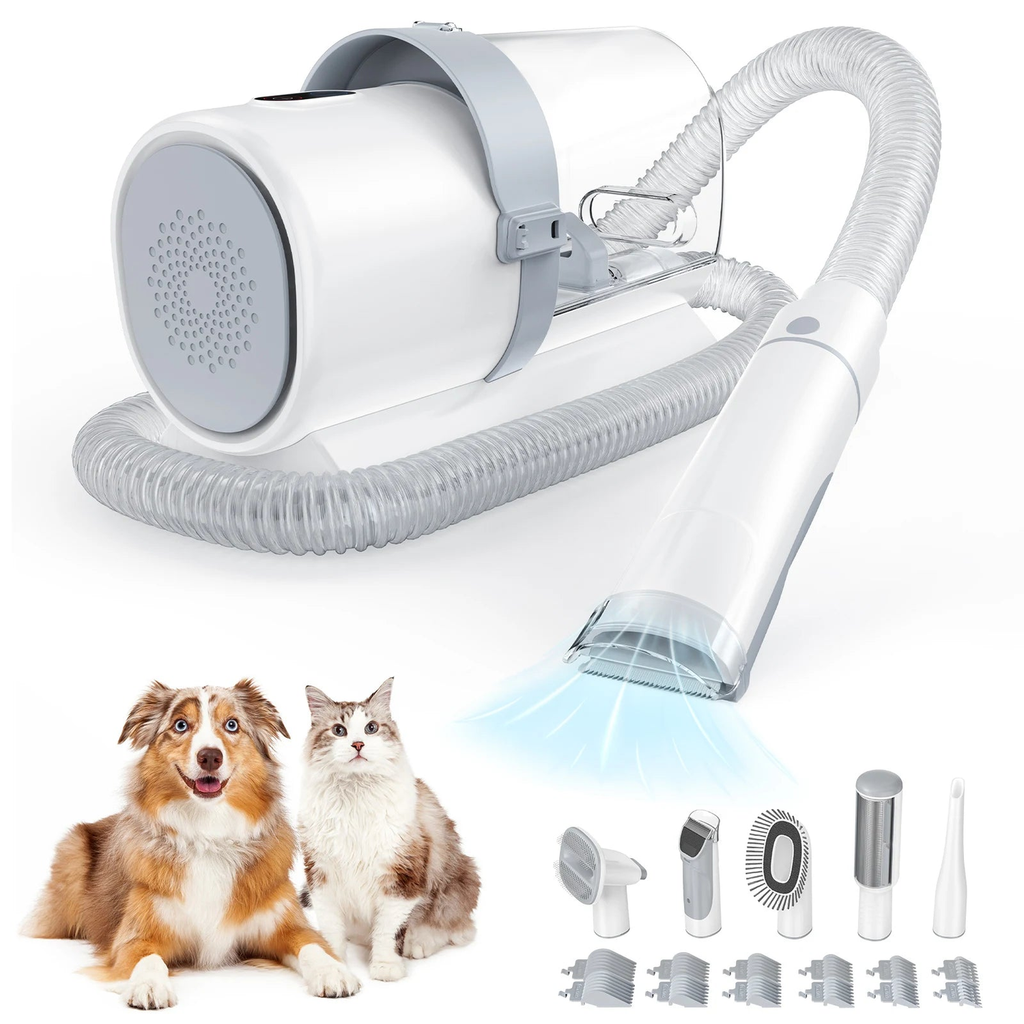 White pet grooming vacuum kit with hose, suction handle, attachment heads and guide combs shown beside a dog and cat
